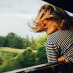 Caucasian woman looking at the view from train window