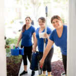 Cleaning ladies working in team arriving at a house